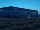 AI data center meeting rural landscape, symbolizing infrastructure expansion and real-world pushback.