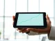 Analyst reviewing Ripple XRP price chart and market data on a digital tablet.