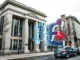 UK government building with holographic cryptocurrency symbols illustrating the new fraud strategy labeling crypto a growing risk.