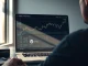 Analyst reviewing Uniswap UNI token price chart and market data on a laptop.