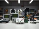Unconventional Bitcoin mining hardware including Game Boy, PlayStation, and Apollo computer on workshop table
