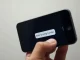 A smartphone displays a 'wrong number' text message, the starting point of a major cryptocurrency scam.