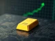 XAUT digital gold token represented by a gold bullion bar on a digital background, symbolizing its entry into Binance's top 10 trading pairs.