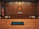Courtroom scene representing the US crypto wash trading case with extradited executives.