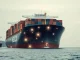Cargo ship with blockchain network overlay illustrating the risk of crypto payments to Iran for shipping firms.