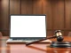Laptop showing AI interface in a courtroom, representing the xAI lawsuit against Colorado's AI regulations.