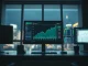 Professional trading desk with Aave price charts and DeFi dashboard on multiple monitors