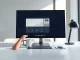 A desk with a computer monitor representing an AI boss system in a modern office setting.
