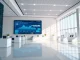 Modern bank lobby with digital display showing AI and stablecoin payment data