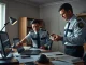 Australian police officers examining a laptop and cryptocurrency wallet during a darknet marketplace investigation in Sydney.