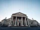 Bank of England building exterior on a clear day, representing UK financial regulation.