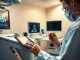 Doctor using ultrasound with AI copilot tablet in a hospital exam room