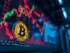 Bitcoin coin in foreground with blurred digital trading chart showing $80,000 level in background