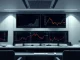 Bitcoin price chart and S&P 500 index on trading monitors showing monthly gains