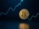 Bitcoin coin with upward market trend lines on a dark background