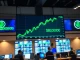 Bitcoin price chart showing bullish breakout above $79,500 on a trading floor display