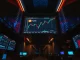 Bitcoin price chart near $80,000 on a trading floor display with altcoin charts in the background