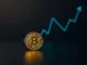 Bitcoin coin with upward price trend symbolizing bullish market momentum
