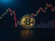 Bitcoin coin on a dark trading desk background with subtle chart lines