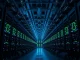 Interior of a large cryptocurrency mining facility with rows of mining rigs lit by blue and green LEDs.