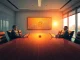 Corporate boardroom with Bitcoin price chart on digital screen and business professionals reviewing data