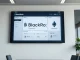 BlackRock digital display showing Treasury fund tokenization on Ethereum in a modern office setting
