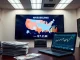 Digital map of US states with crypto PAC spending data and campaign materials on desk