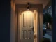 Secure residential entrance at dusk with surveillance camera, representing crypto holder safety concerns in France.