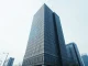 Sleek corporate building in Shenzhen with digital data streams symbolizing DeepSeek's AI growth and funding news.