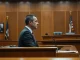 Elon Musk testifying in a courtroom during his lawsuit against OpenAI