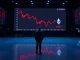 A dark trading floor with a large digital screen showing a declining Ethereum price chart, reflecting bearish market sentiment.