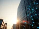 Modern office building exterior with digital network overlay symbolizing Hedera's enterprise blockchain technology