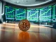 Bitcoin coin on table with blurred financial charts in background