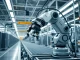 Industrial robot performing assembly work in a Japanese factory, representing the physical AI sector.