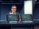 John Oliver discussing prediction markets on Last Week Tonight with financial data screens.