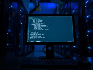 Linux Copy Fail vulnerability exploit code on a terminal screen in a server room, illustrating the CISA KEV catalog addition.