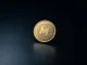 Monero (XMR) coin on dark reflective surface, symbolizing privacy and security in cryptocurrency