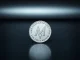 Monero (XMR) coin on a dark metallic surface, symbolizing privacy-focused cryptocurrency analysis.