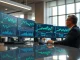 Professional analyst using AI trading tool on monitors showing prediction market dashboards
