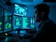 Cybersecurity analyst monitoring screens showing North Korean hacking activity and crypto theft data.