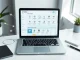 Notion interface on a laptop showing AI agent icons and workflow connections in a bright office setting.