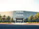 Nvidia headquarters building exterior on a sunny day, representing the company's corporate presence and AI investment activity.