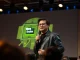 Nvidia CEO Jensen Huang speaking on stage at a tech event with a Vera CPU graphic behind him.