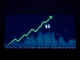 Ripple XRP price prediction 2026: A digital XRP coin on a reflective surface with a financial chart background