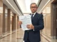 Russian official holding proposed cryptocurrency regulation bill with criminal penalties.