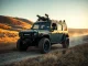 Autonomous military ATV from Scout AI navigating a dusty trail at a California military base during training