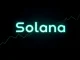 Solana blockchain logo with glowing green and blue colors on a dark futuristic chart background