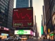 Seoul financial district with a digital billboard showing a declining crypto chart and rising stock chart at dusk.