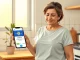 Stablecoin remittance LATAM opportunity: Woman checking a stablecoin transaction on her phone in a Latin American home