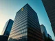 Corporate headquarters building at dusk with a subtle Bitcoin symbol glowing in a window, representing Strategy's Bitcoin treasury strategy.
